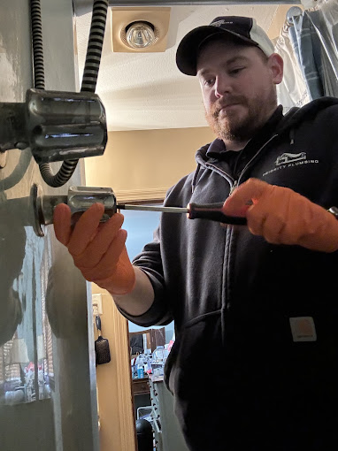 A man is working on a door handle